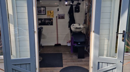 Entrance view of The Garden Salon Hair Design in Colchester, England, GB showing stylish interior.
