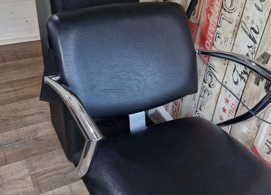 Modern salon chair at The Garden Salon Hair Design, Colchester, England, GB, on rustic wooden floor.