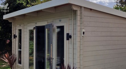 Charming garden studio at The Garden Salon Hair Design, Colchester, England, GB, offering peaceful wellness services.