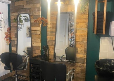 Warm and inviting salon setup at Hair by Bee at Beautifly nails and beauty in Halstead, England, GB, with wood accents.