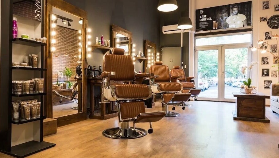 Modern barber chairs at Clean Cut, Budapest, Magyar, HU enhance the stylish interior for premium grooming.