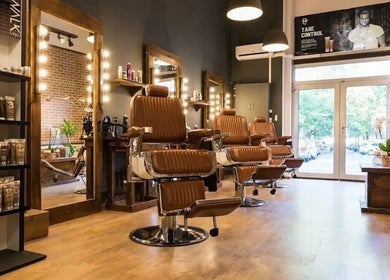 Modern barber chairs at Clean Cut, Budapest, Magyar, HU enhance the stylish interior for premium grooming.