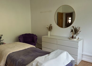 Relaxing treatment room at The Lash & Brow Co, Maidenhead, England, GB with cozy bed and stylish decor.