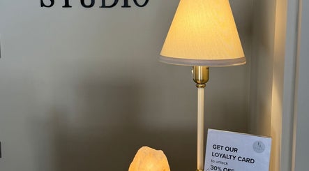 Cozy entrance at LN Beauty Witney in Witney, England, GB with a stylish lamp and loyalty card offer.