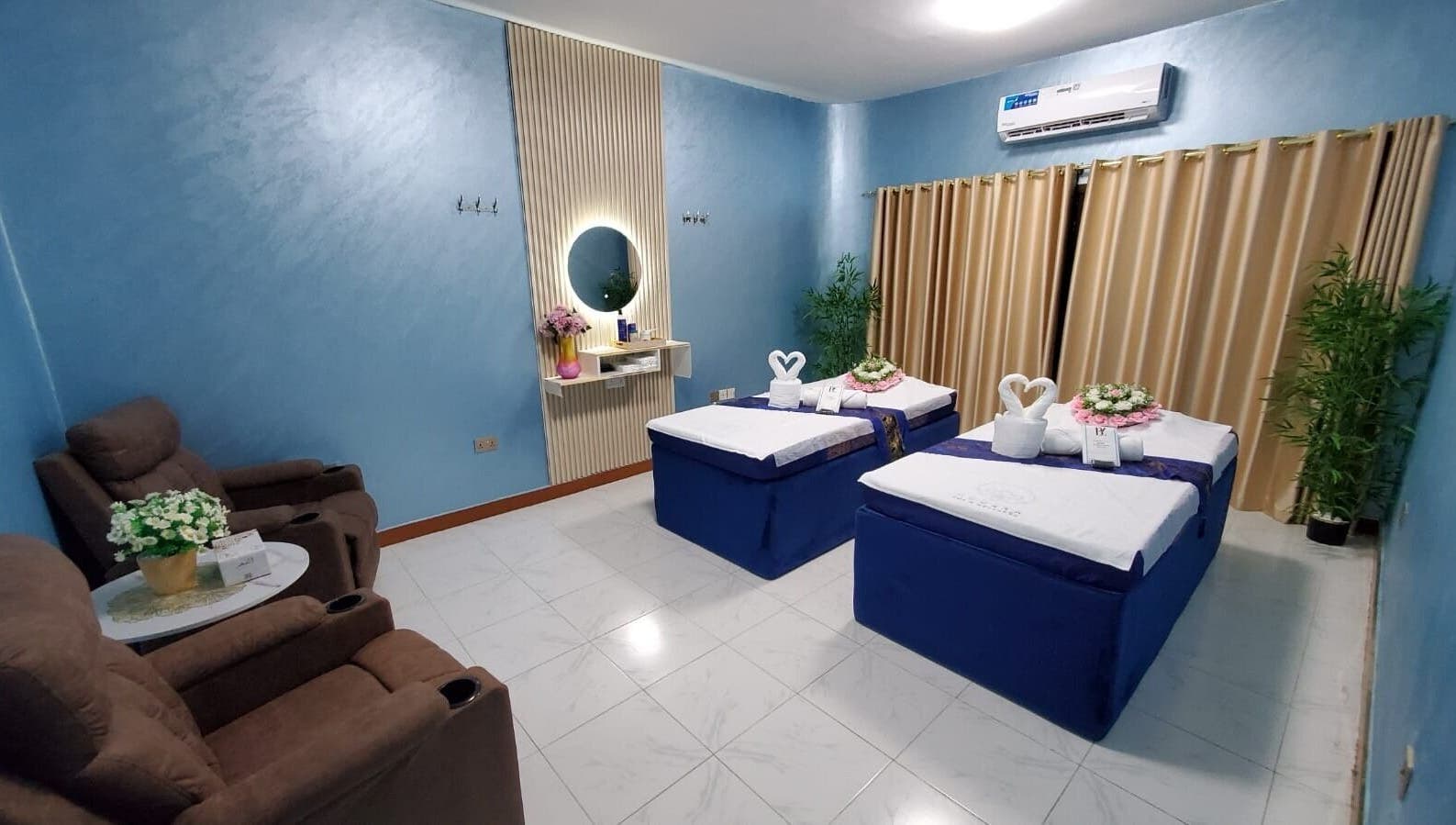 Luxurious massage room at Modiva Spa and Wellness, Al Ain, Abu Dhabi, AE, featuring plush massage tables and decor.