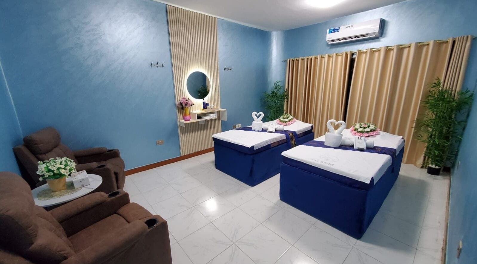 Luxurious massage room at Modiva Spa and Wellness, Al Ain, Abu Dhabi, AE, featuring plush massage tables and decor.