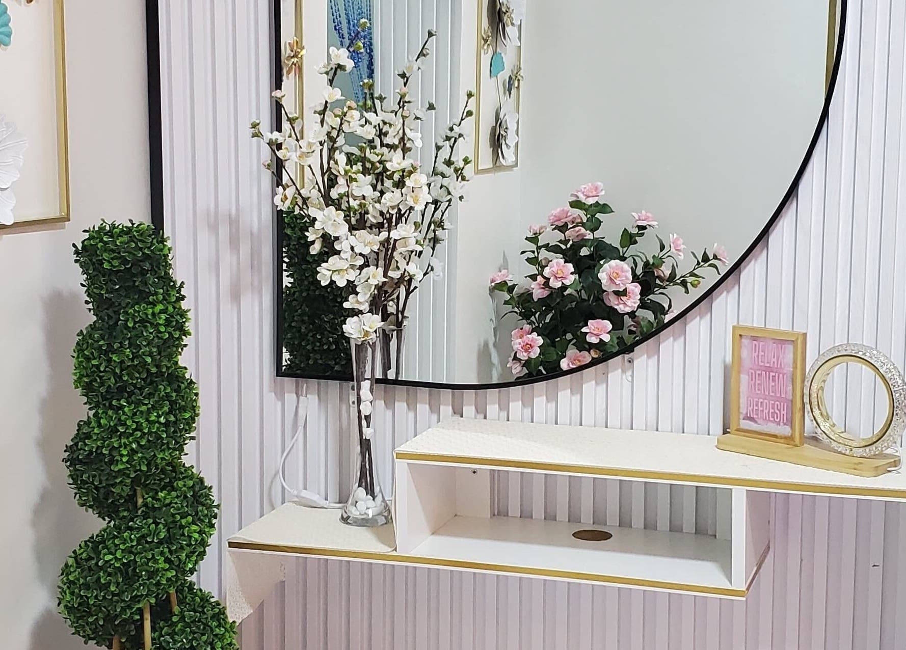 Elegant floral decor at Modiva Spa and Wellness, Al Ain, Abu Dhabi, AE, enhancing a mirror setup.