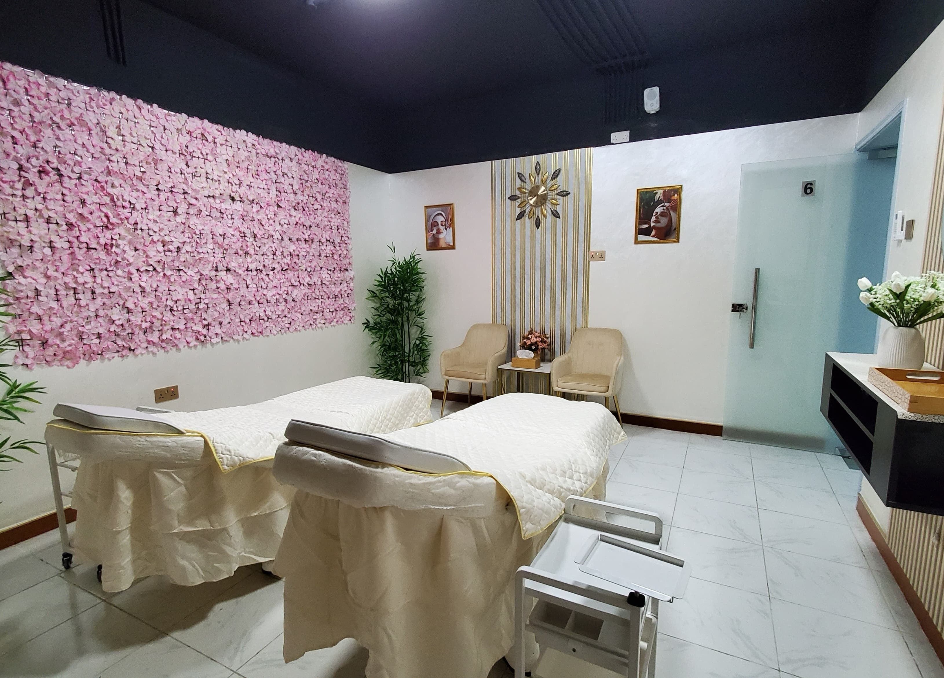 Relaxing treatment room at Modiva Spa and Wellness, Al Ain, Abu Dhabi, AE with elegant decor and treatment beds.