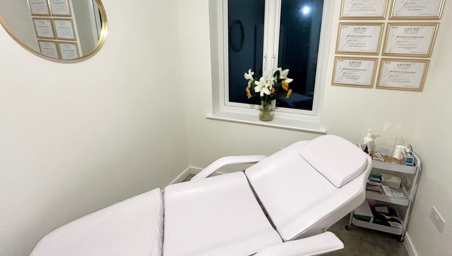 Serene treatment room at Aura Aesthetics by Abbie, Chilton, England, GB featuring a comfortable chair.