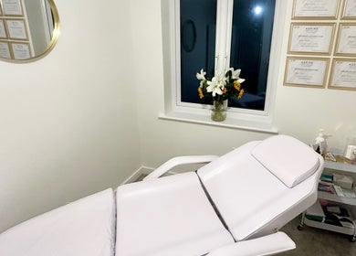 Serene treatment room at Aura Aesthetics by Abbie, Chilton, England, GB featuring a comfortable chair.