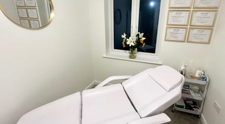 Serene treatment room at Aura Aesthetics by Abbie, Chilton, England, GB featuring a comfortable chair.