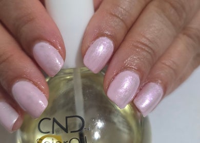 Elegant pink manicure at NailsbyAjita, Northwood, England, GB showcasing a glossy finish.
