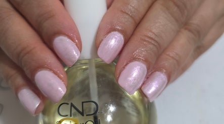 Elegant pink manicure at NailsbyAjita, Northwood, England, GB showcasing a glossy finish.
