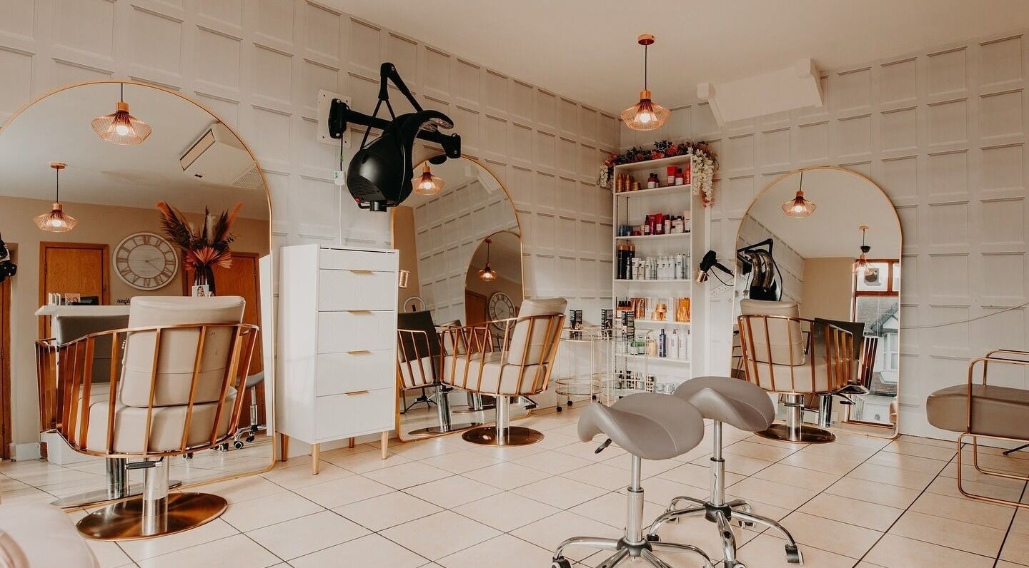 Elegant interior of Kenny’s Hair Boutique, Oxford, England, GB showcasing modern salon chairs and styling stations.
