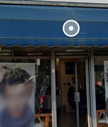 Front of Menova beauty salon in Greenford, England. Stylish images adorn the entrance.