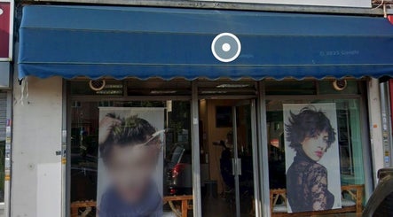 Front of Menova beauty salon in Greenford, England. Stylish images adorn the entrance.
