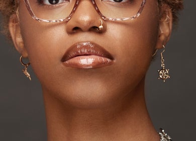 Woman with elegant style at Carmenglitz.inc, New York, New York, US, wearing stylish earrings and glasses.