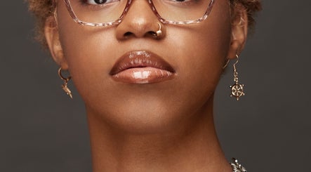 Woman with elegant style at Carmenglitz.inc, New York, New York, US, wearing stylish earrings and glasses.