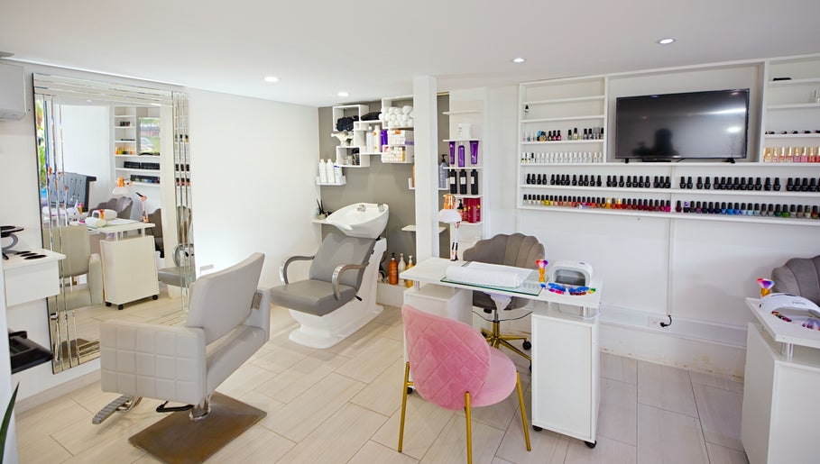 Modern salon interior at Garra Beauty Spa, Simpsonbay, SX with chairs, nail polish display, and hair washing station.