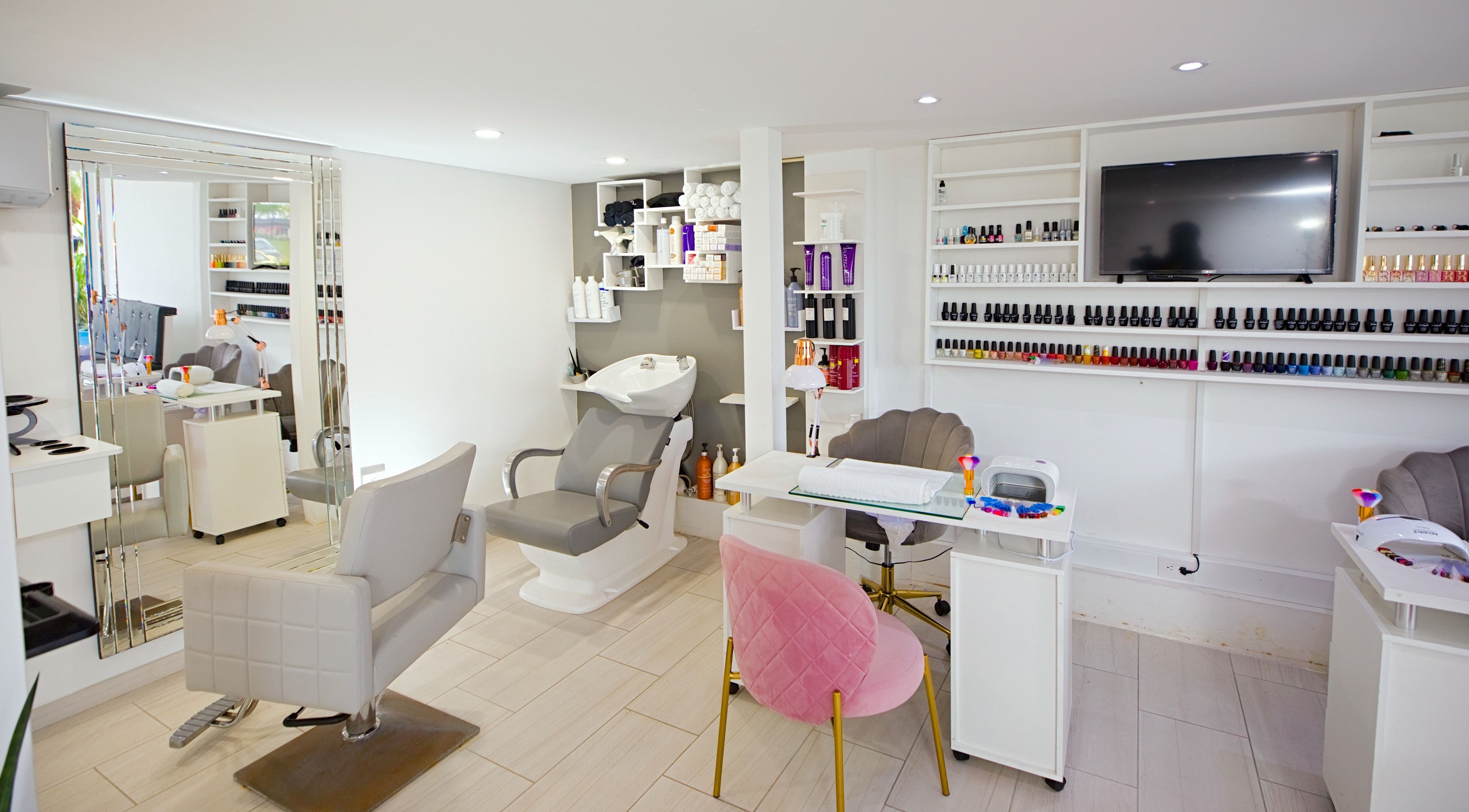Interior of Garra Beauty Spa in Simpsonbay, SX showcasing modern salon chairs and nail polish shelves.