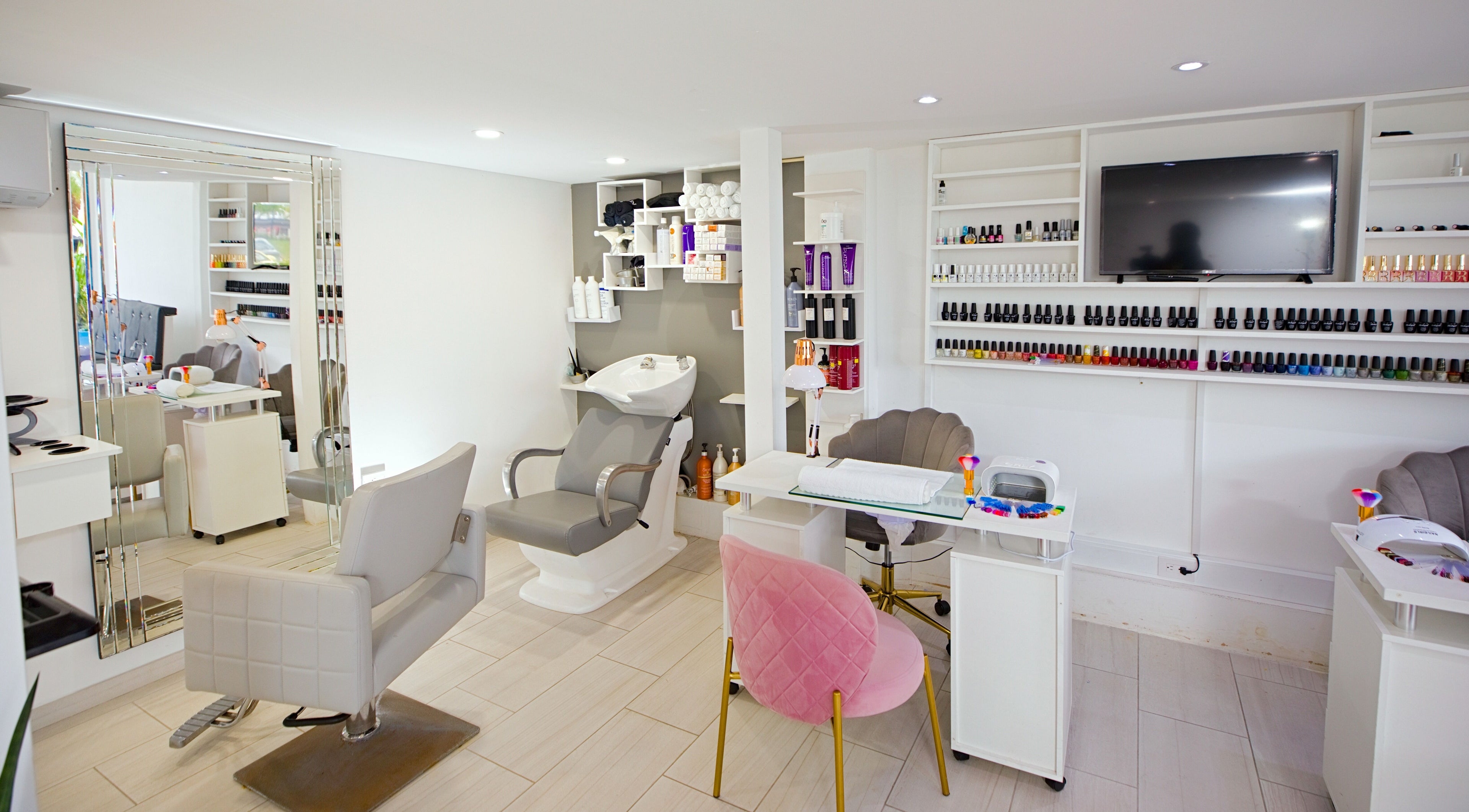 Interior of Garra Beauty Spa in Simpsonbay, SX showcasing modern salon chairs and nail polish shelves.