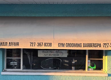 Front view of Beach Hair Affair, a beauty venue in St. Petersburg, Florida, US with large awning signage.