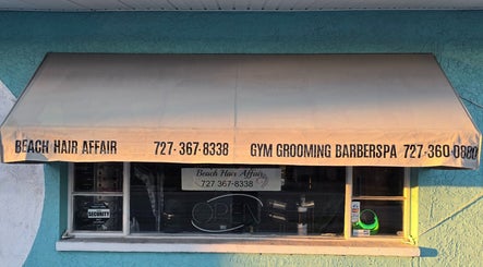 Front view of Beach Hair Affair, a beauty venue in St. Petersburg, Florida, US with large awning signage.