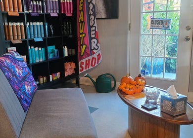 Warm interior of Beach Hair Affair, St. Petersburg, Florida, showcasing a comfortable seating area and products.