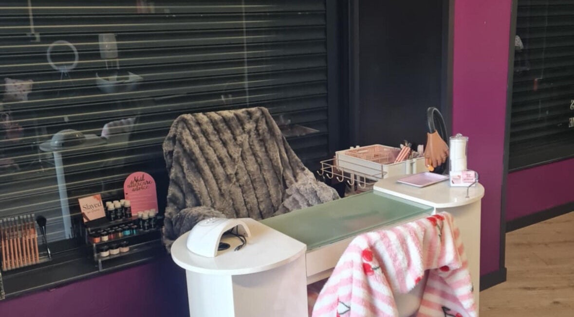 Nail station at Slayed.by.steffy in Ayr, Scotland, GB, featuring plush chair and nail care essentials.