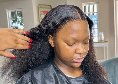 Customer getting a hairstyle at Cateon Luxury, Pretoria, Gauteng, ZA, showcasing expert hairdressing skills.