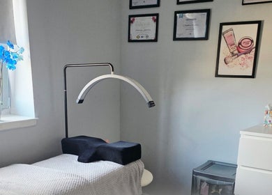 Calming treatment room at Chic Beauty By M.W, Edinburgh, Scotland, GB with blue orchids and elegant decor.