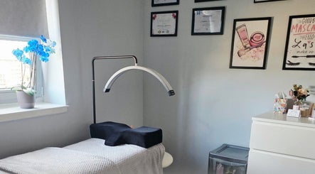 Calming treatment room at Chic Beauty By M.W, Edinburgh, Scotland, GB with blue orchids and elegant decor.