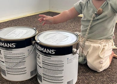 Child with paint cans at Tiny Tree Kids Yoga, Broadbeach, Queensland, AU.