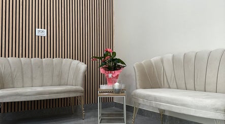 Elegant seating at Glam Nails by Sheemu in Roma, Lazio, IT with plush sofas and modern decor.