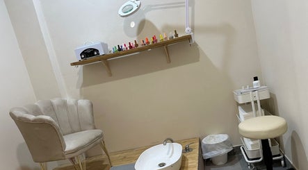 Relaxing pedicure space at Glam Nails by Sheemu in Roma, Lazio, IT, featuring elegant seating and nail polish display.