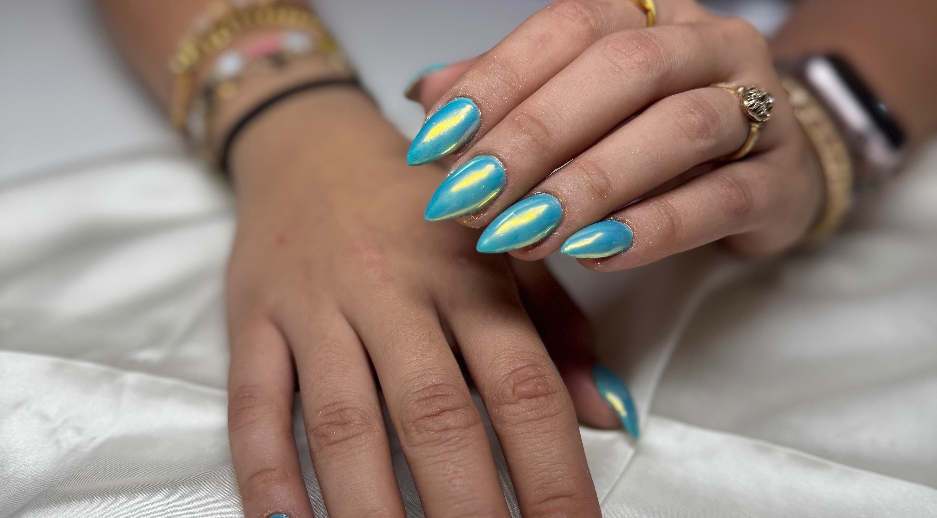 Blue iridescent nails at Kai nails, Aguada, Aguada, PR showcasing stylish nail art.