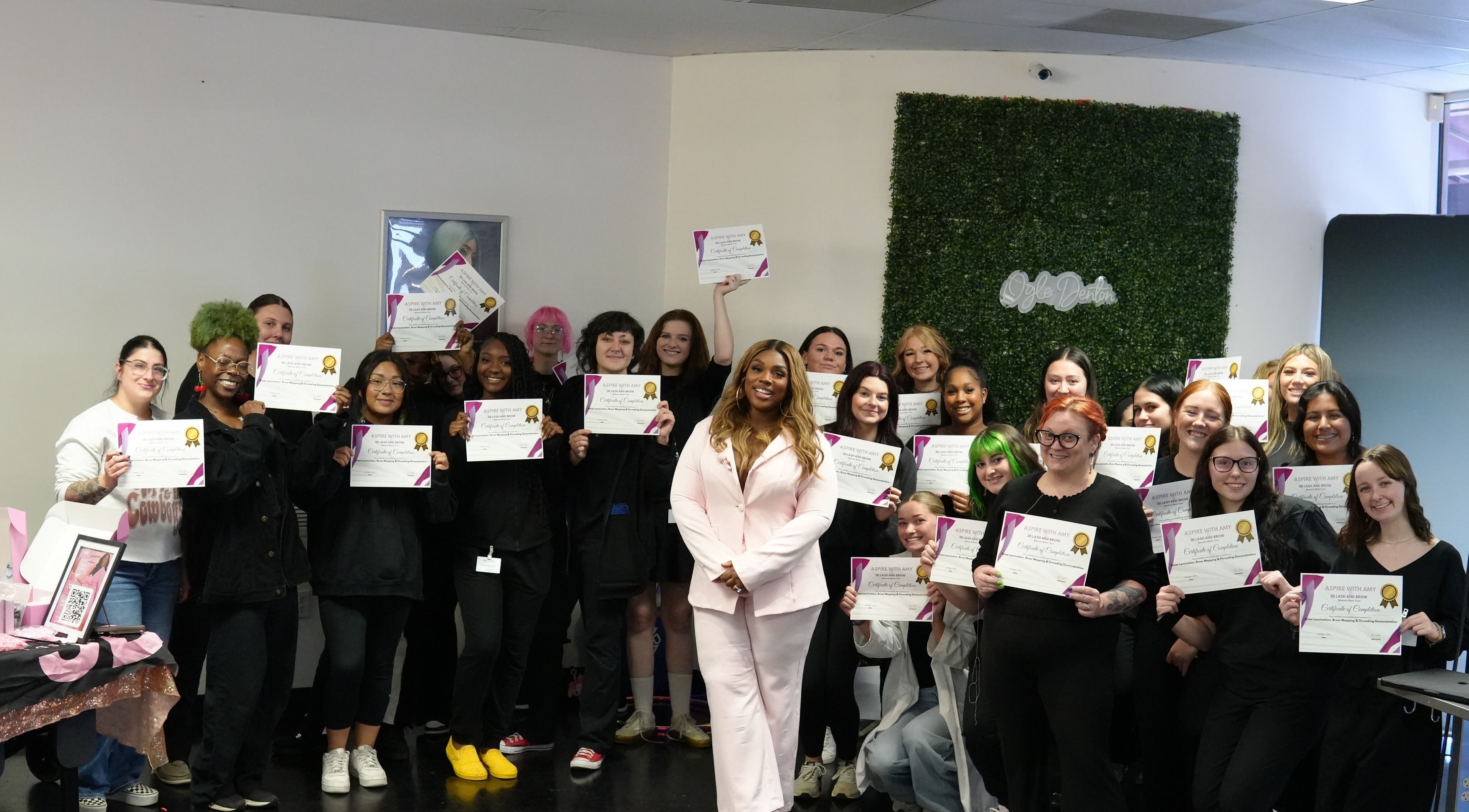Graduates celebrate at 3D Lash & Brow Academy in Dallas, Texas, US, holding certificates with pride.