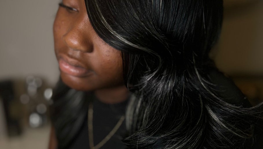 Close-up of sleek hair styling at FéLuxe Hair in Richmond, Virginia, US, showcasing vibrant dark tones.