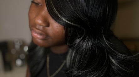 Close-up of sleek hair styling at FéLuxe Hair in Richmond, Virginia, US, showcasing vibrant dark tones.