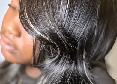 Elegant black hair with highlights styled in waves at FéLuxe Hair, Richmond, Virginia, US.
