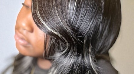 Elegant black hair with highlights styled in waves at FéLuxe Hair, Richmond, Virginia, US.