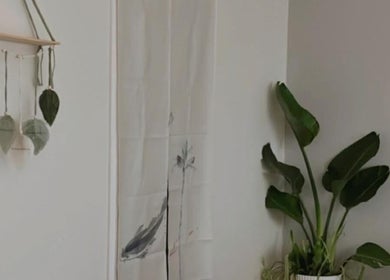 A serene corner at SASA Beauty Studio, Saint Albans, Victoria with wall art and a potted plant.