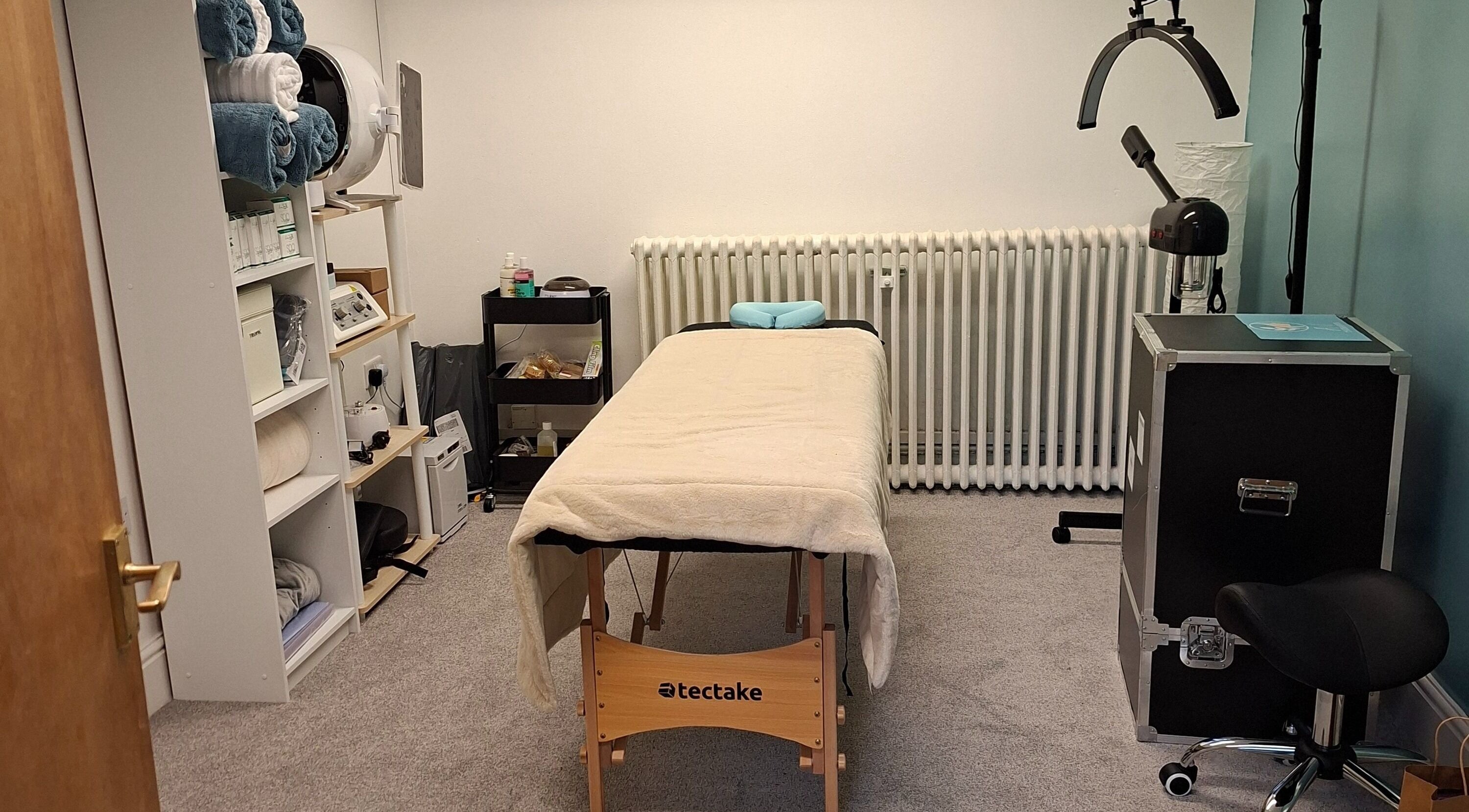 Relaxing treatment room at AW Therapies, Haverfordwest, Wales, GB, featuring massage table and essential spa equipment.