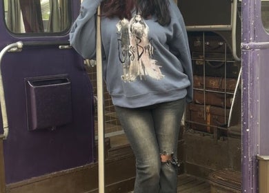 Woman in cozy outfit on a vintage bus at NailsByZeff, Bridgwater, England, GB.