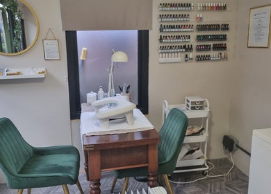 Beauty Bank in Clitheroe, England, GB offers a cozy nail care space with elegant seating and organized supplies.