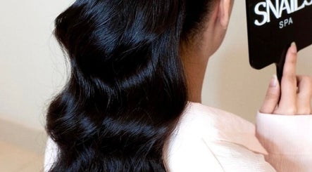 Silky wavy hair styled at Snails, Riyadh, Riyadh Province, SA, reflecting beautiful grooming services.