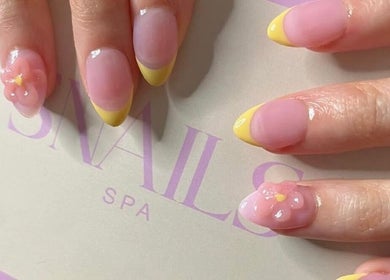 Elegant floral nail art at Snails, Riyadh, Riyadh Province, SA, showcasing yellow tips and pink accents.