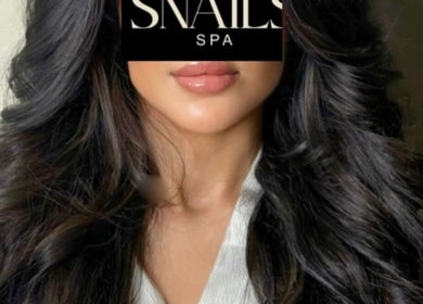 Luxurious wavy hairstyle at Snails, Riyadh, Riyadh Province, SA, showcasing glossy, dark hair.