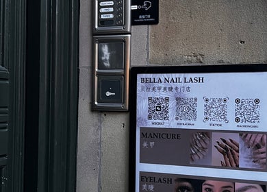 Bella Naillash entrance sign with service details and QR codes in Manchester, England, GB.