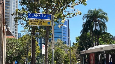 Clarkie Station at Clark Lane in Milton, Queensland, AU, nestled among lush trees and modern buildings.